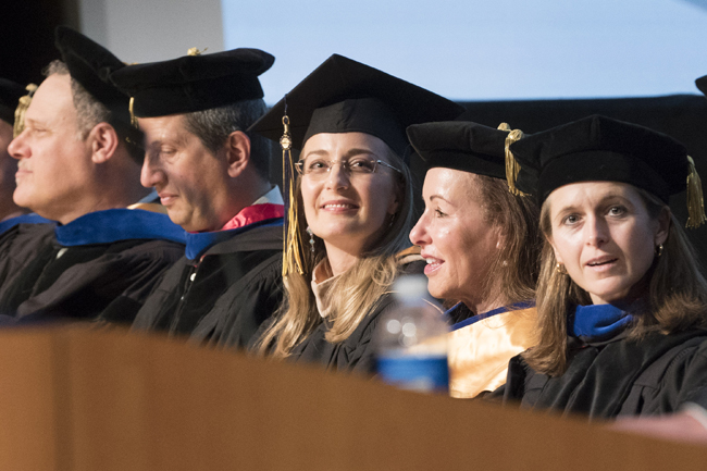 EMBA 2014 valedictorian, Laura Adint (middle) flanked by faculty and staff during graduation. (L-R Jay Stowsky, Andy Rose, Laura, Jenny Chatman, Catherine Wolfram). Courtesy photo