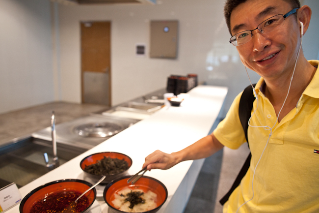 A participant in a CEIBS EMBA program fixes up a bowl of soup for breakfast     - Ethan Baron photo